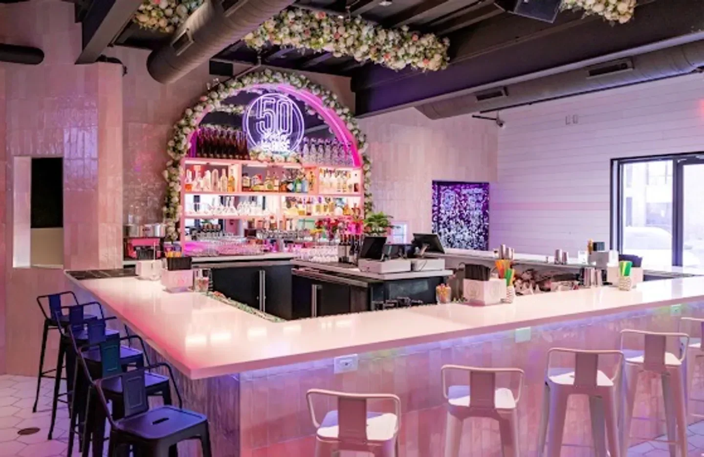 Stylish bar interior at 50 Shades of Rose nightclub in Scottsdale, with floral decor