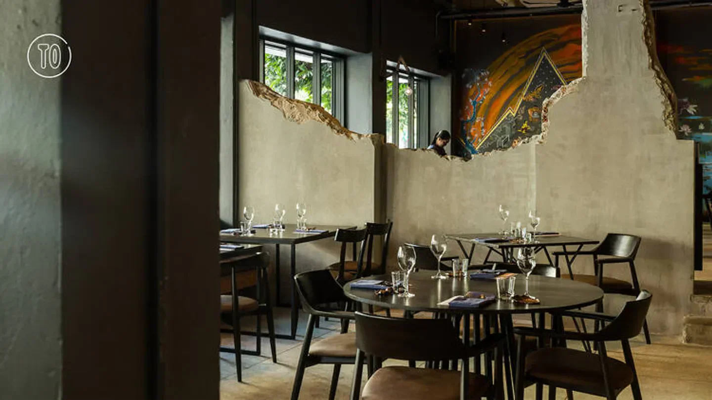 Interior of 80/20 Eighty Twenty restaurant in Bangkok with stylish tables and wall art