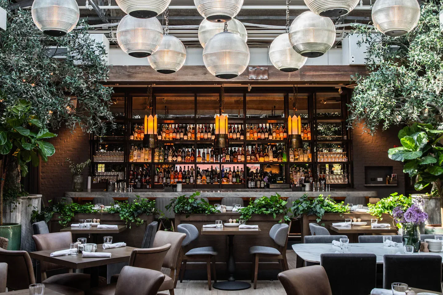 Stylish bar and dining area at Aba - Chicago restaurant in Chicago, with bright lights.