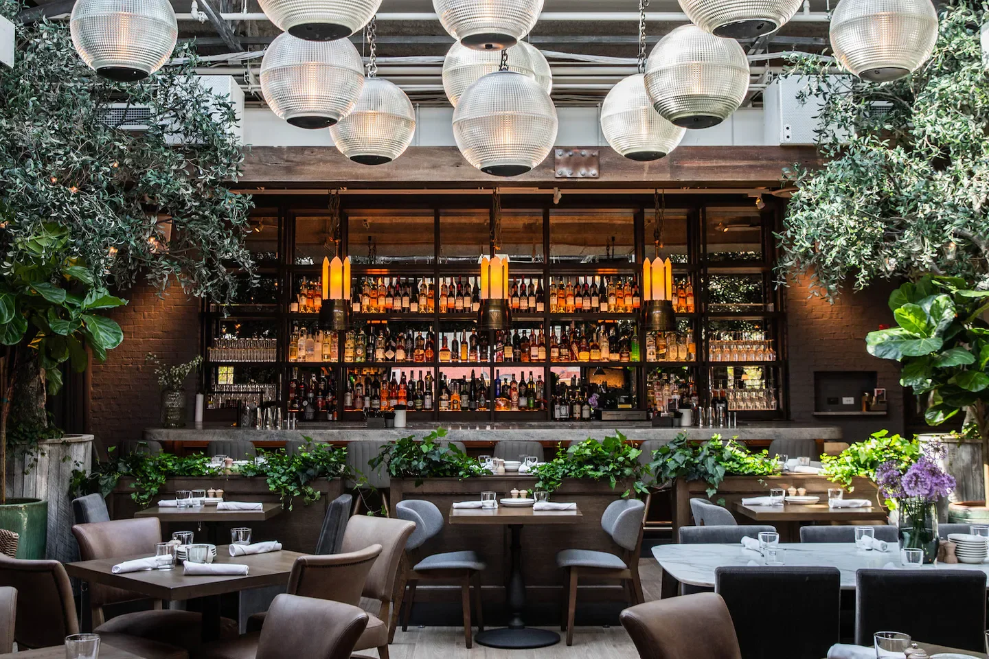 Stylish bar and dining area at Aba - Chicago restaurant in Chicago, with bright lights.