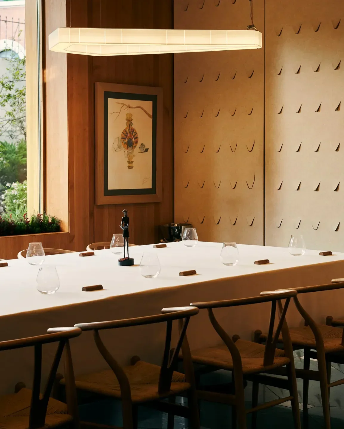 Elegant dining room interior at A'Barra restaurant in Madrid, with a long table set