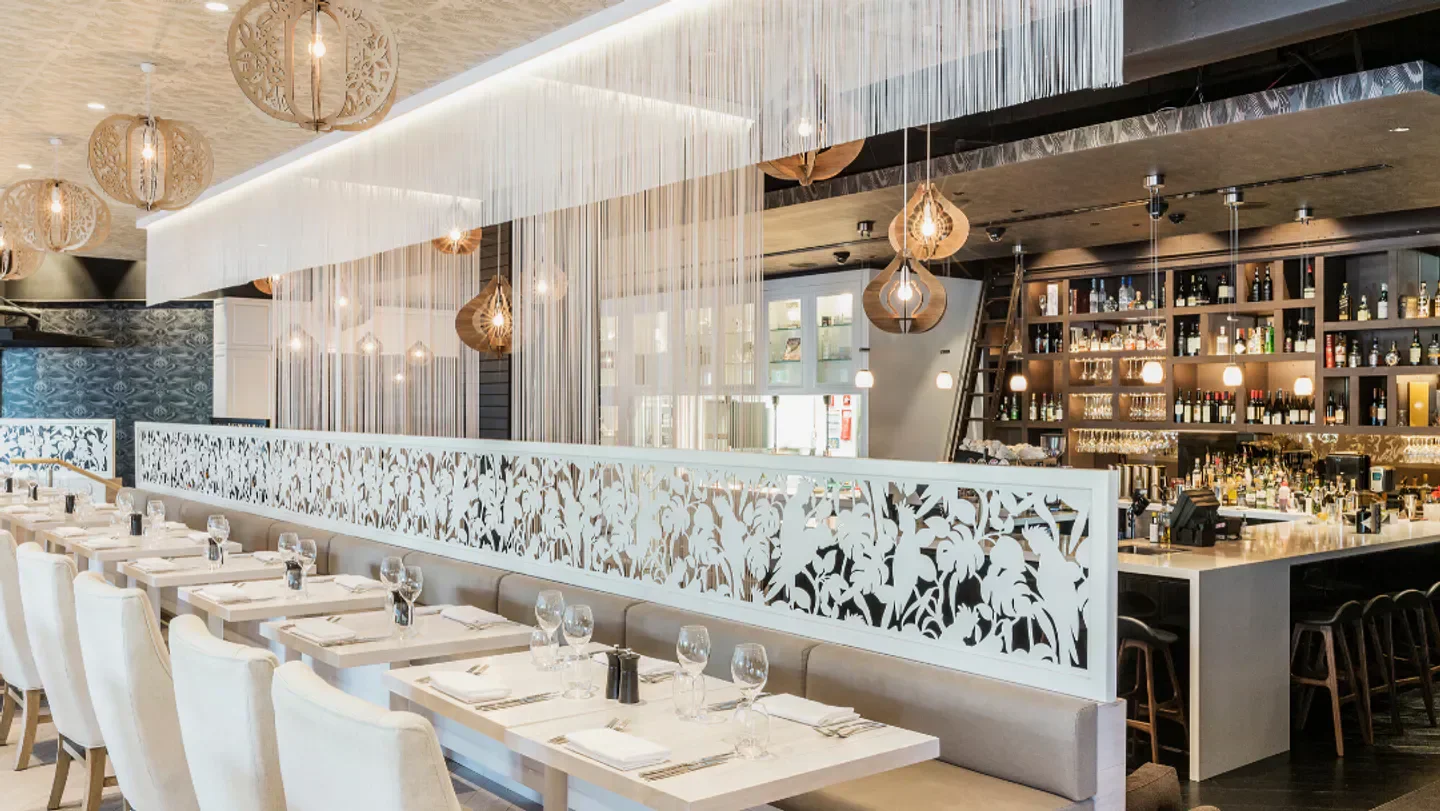 Elegant dining area at ABODE Bistro Bar in Sydney, featuring stylish decor and bar.