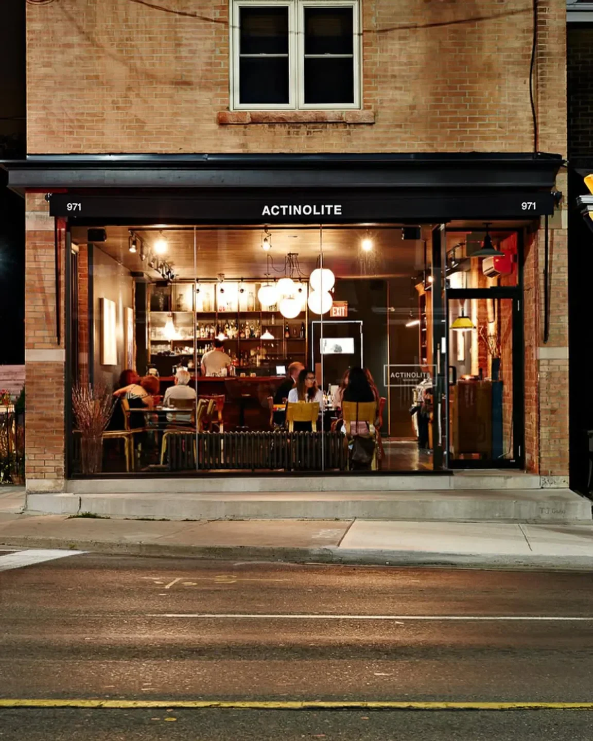 Exterior of Actinolite restaurant in Toronto, inviting dining experience with soft lighting.