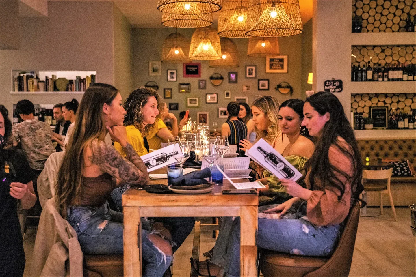 Group of friends at Ada's Food Wine in Las Vegas, dining and reading menus