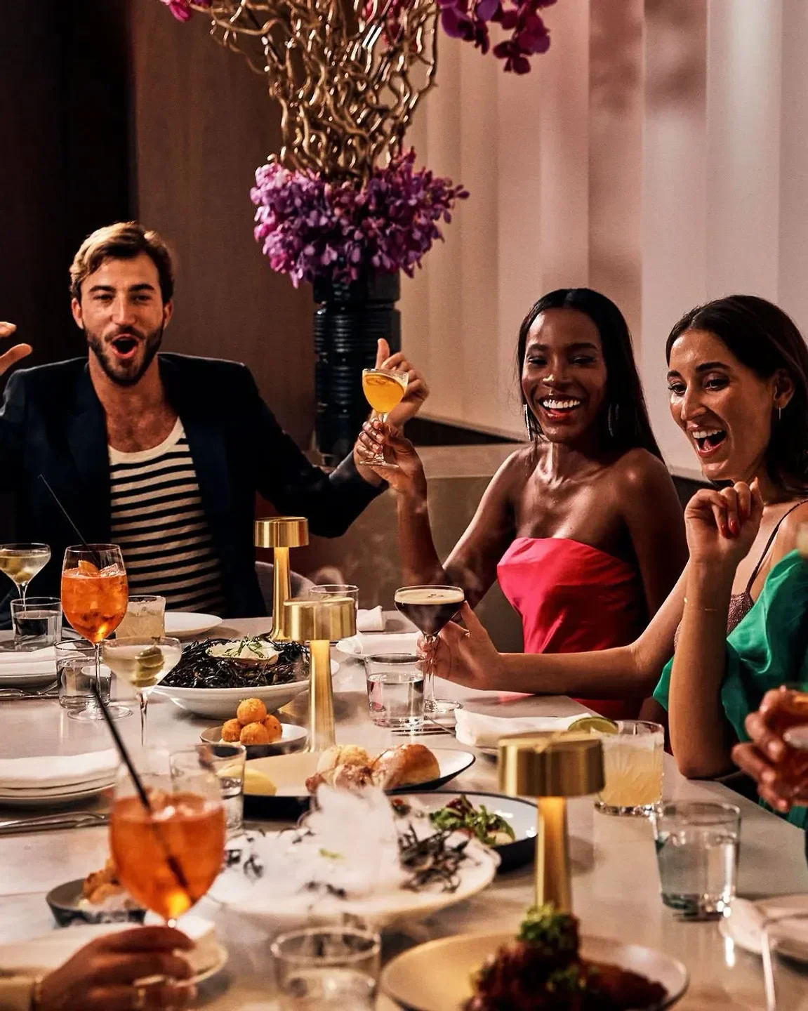 Friends enjoying cocktails and dinner at Adorn Bar & Restaurant in Chicago.