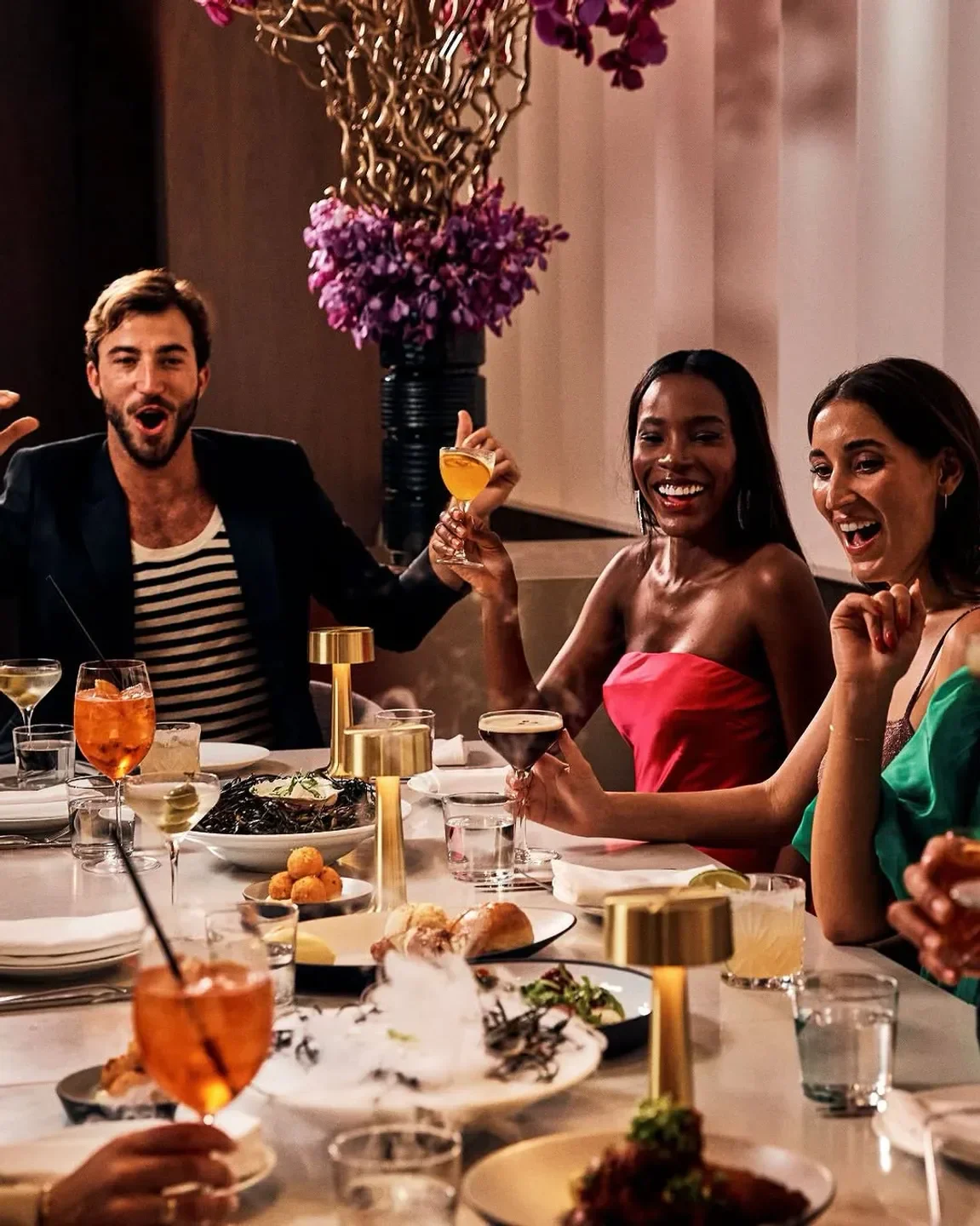 Friends enjoying cocktails and dinner at Adorn Bar & Restaurant in Chicago.