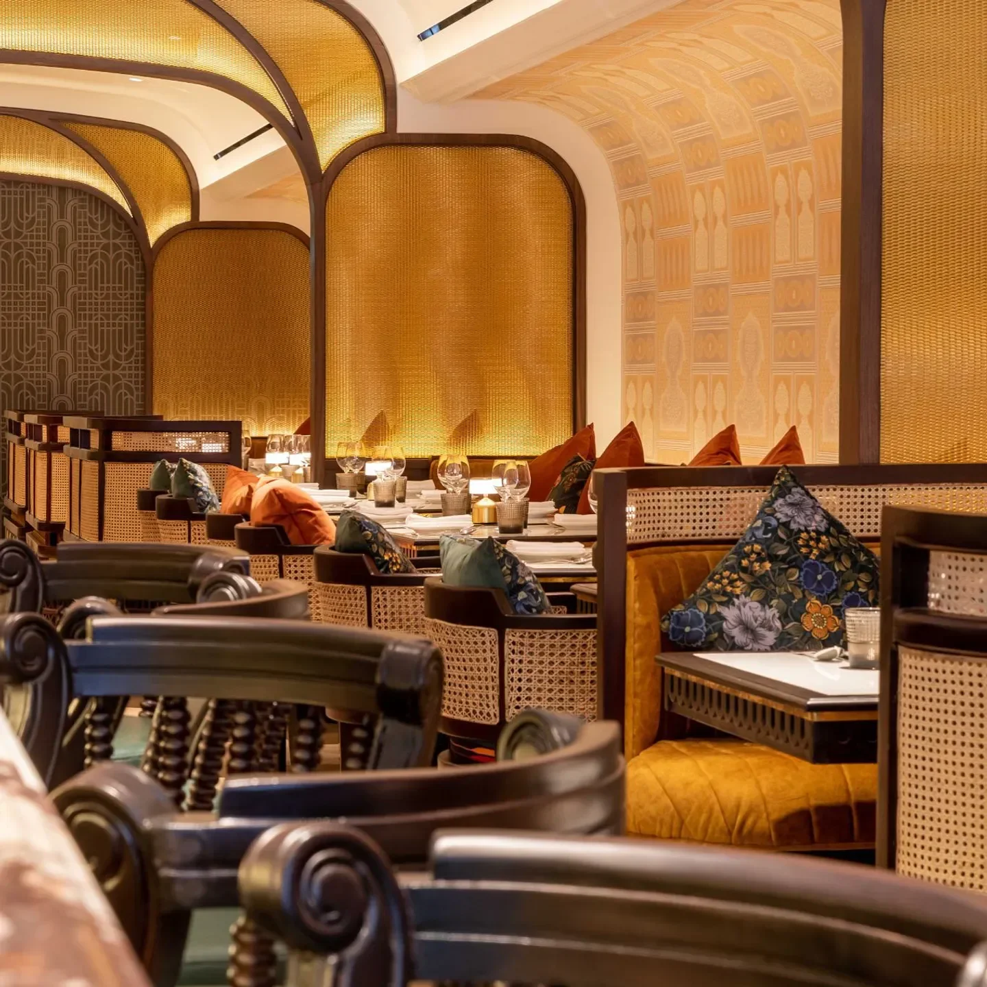 Elegant dining interior at Adrak Yorkville, Toronto with ornate wooden chairs and decor.