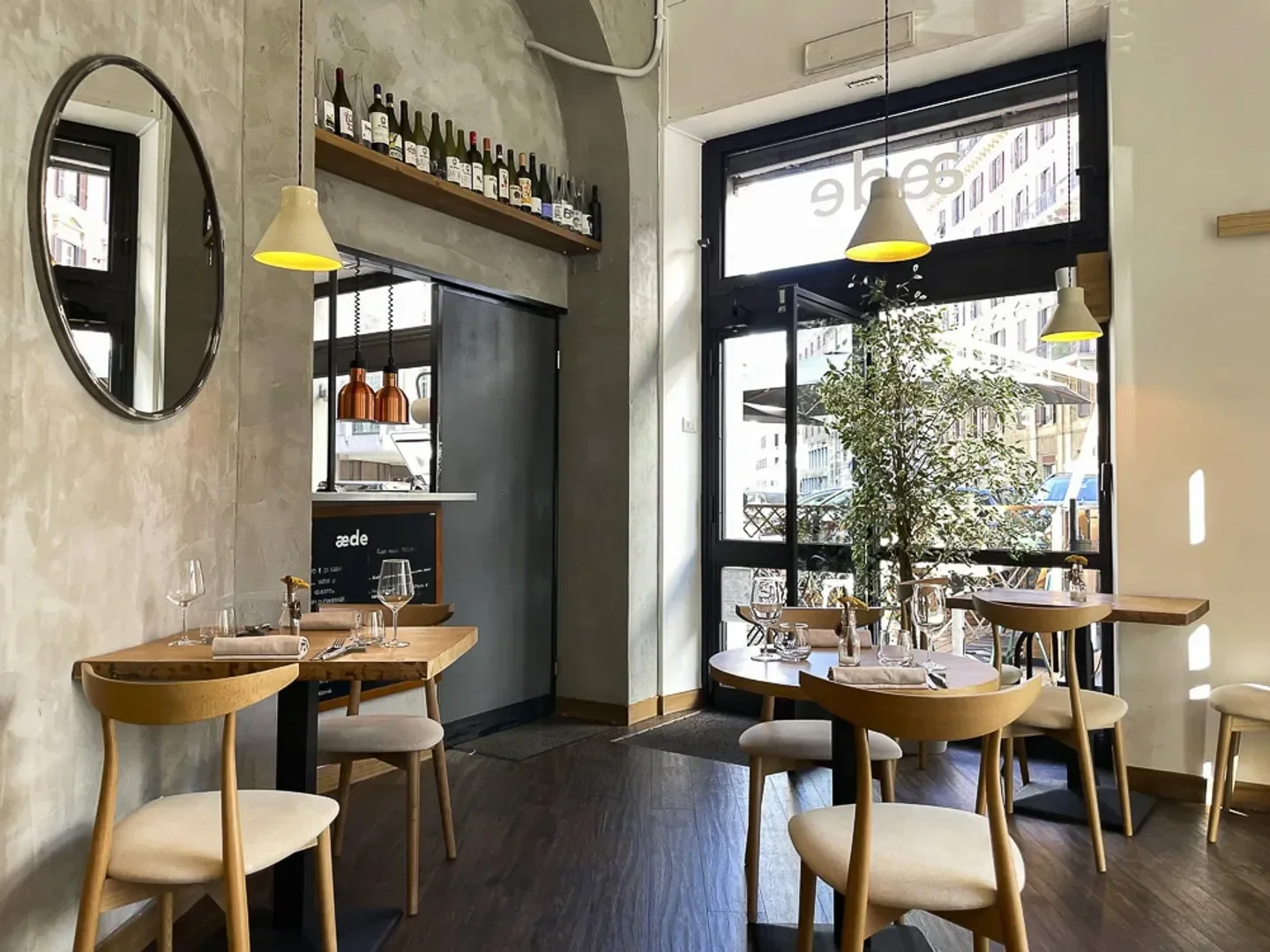 Cozy interior of Aede restaurant in Rome, featuring stylish decor and inviting ambiance.