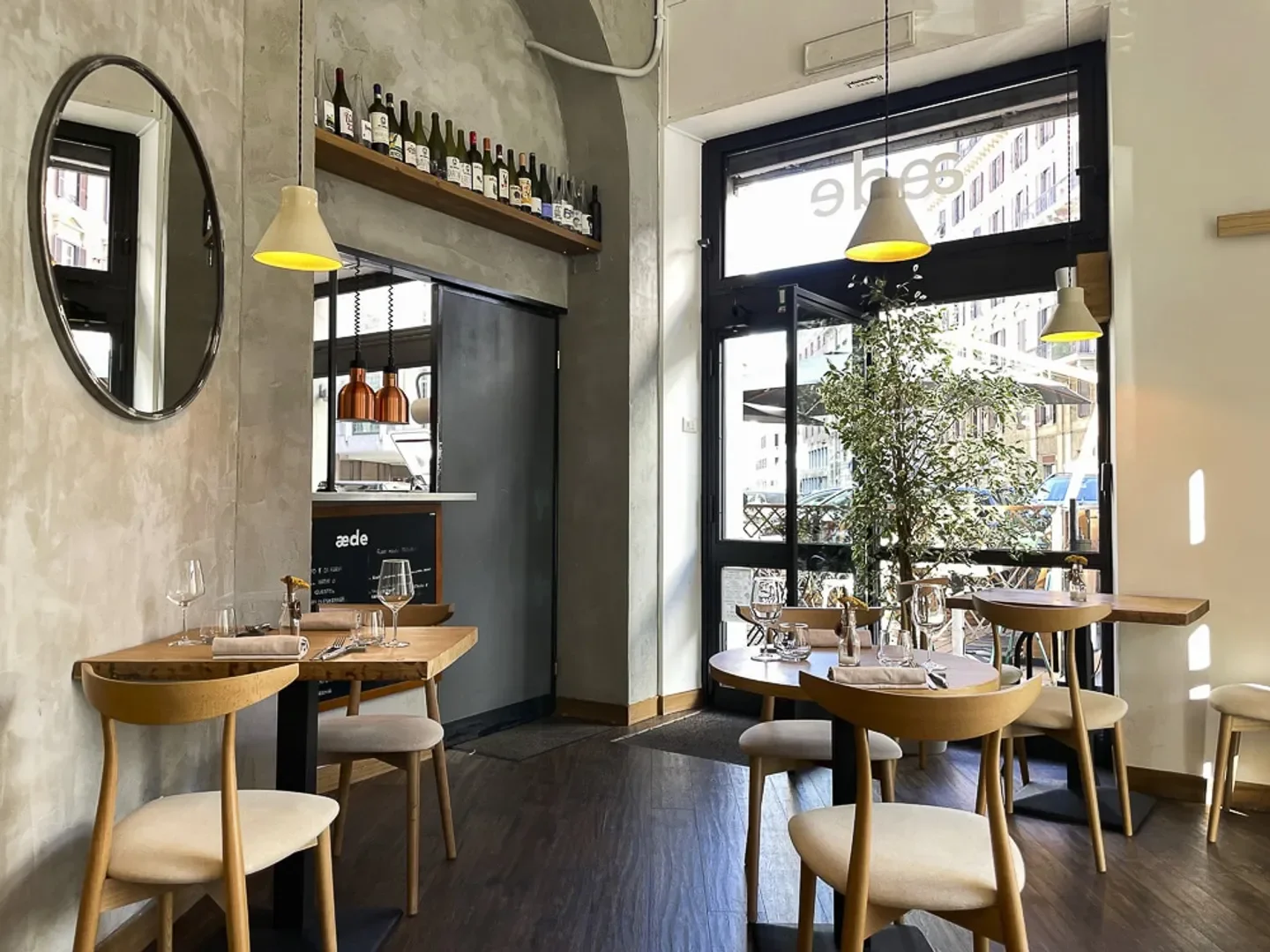 Cozy interior of Aede restaurant in Rome, featuring stylish decor and inviting ambiance.