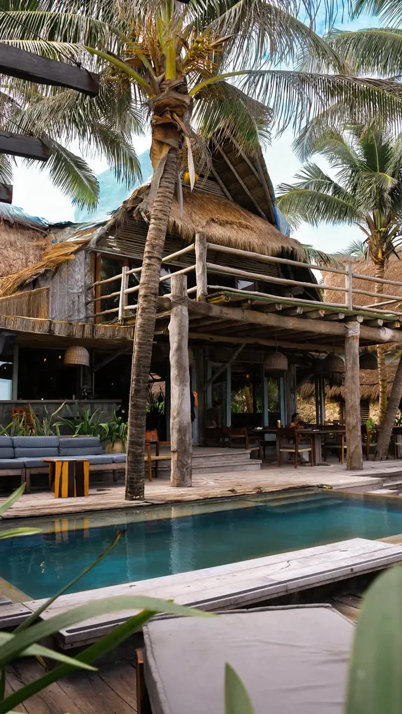 AHAU Tulum restaurant: Tropical design with pool and palm trees in Mexico.