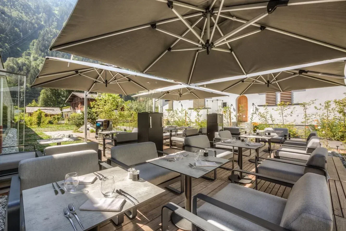 Outdoor dining area at Akashon restaurant in Chamonix, with mountain views and elegant setting.
