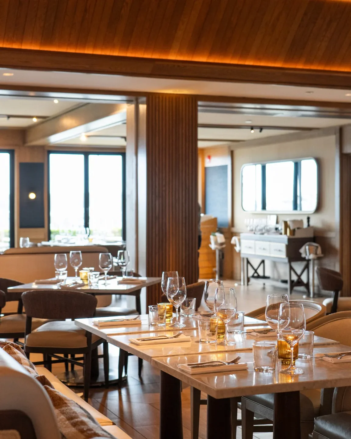 Alba LA restaurant interior with elegant table settings and warm wood accents