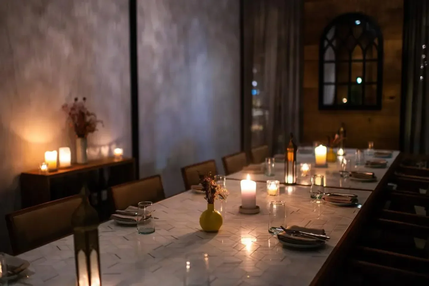 Elegant dining at Albi restaurant in Washington, DC, featuring candles and intimate setting.