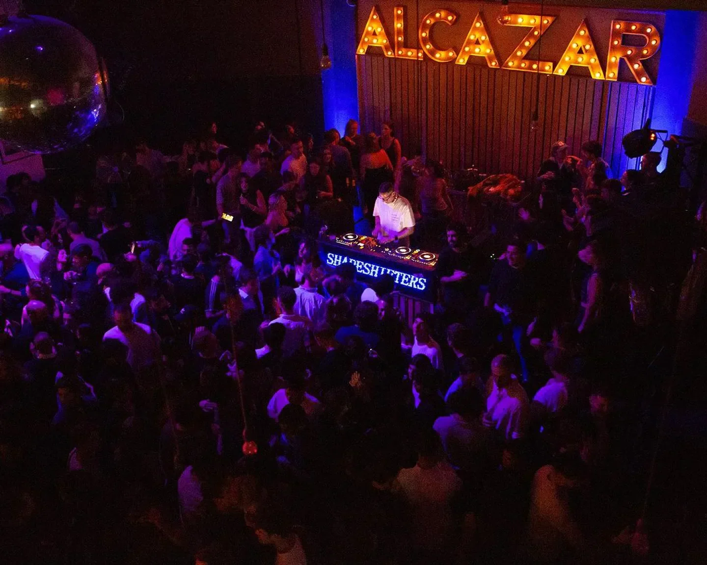 Energetic crowd at ALCAZAR nightclub in Rome, enjoying a live DJ set.
