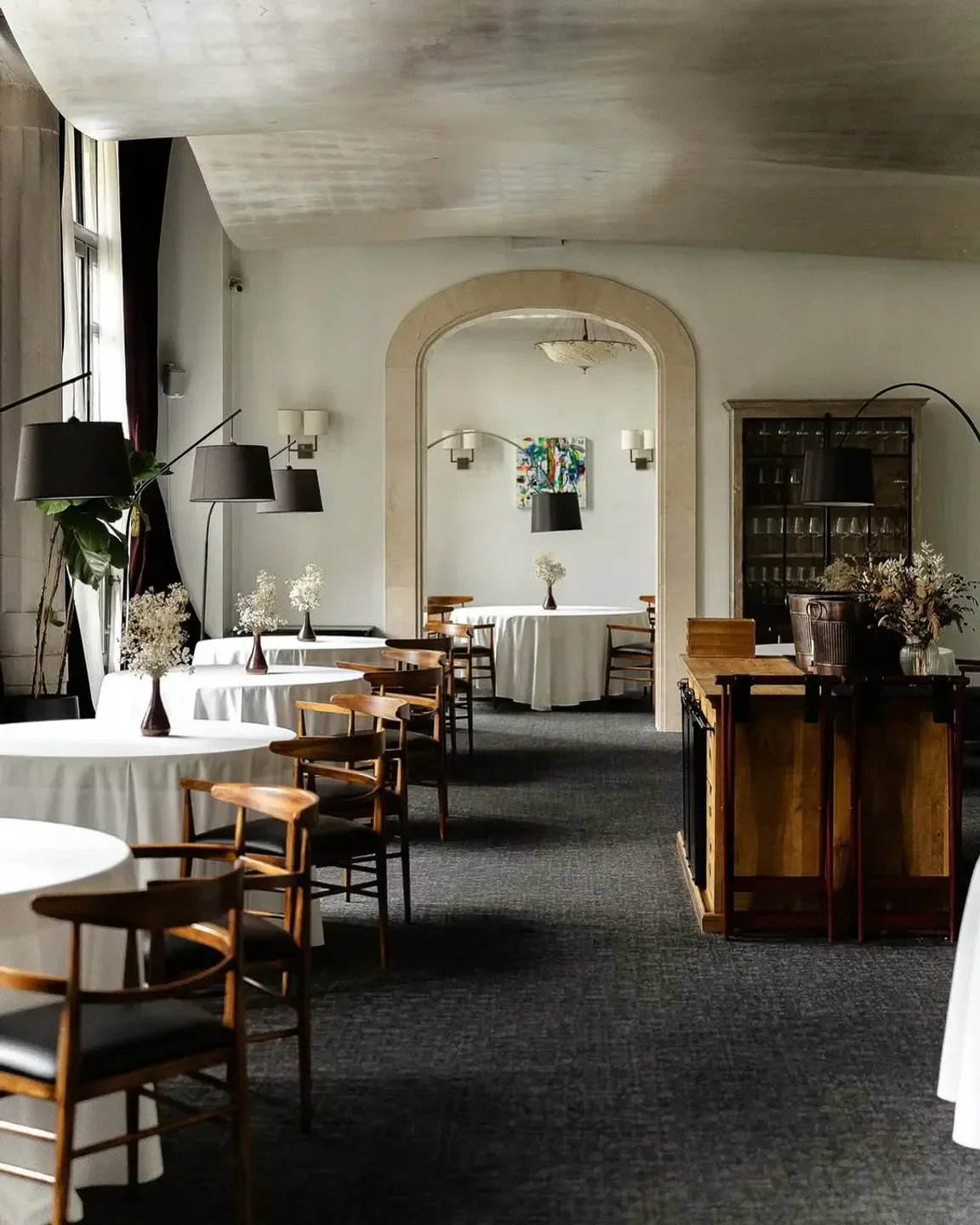 Elegant interior of Aleia restaurant in Barcelona, with round tables and stylish lighting.