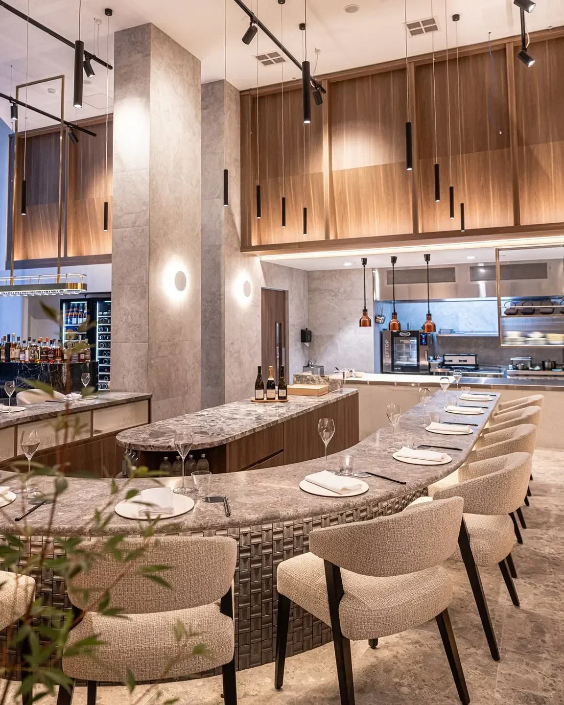 Interior of Allta restaurant in Sydney, featuring a stylish marble bar and modern lighting.