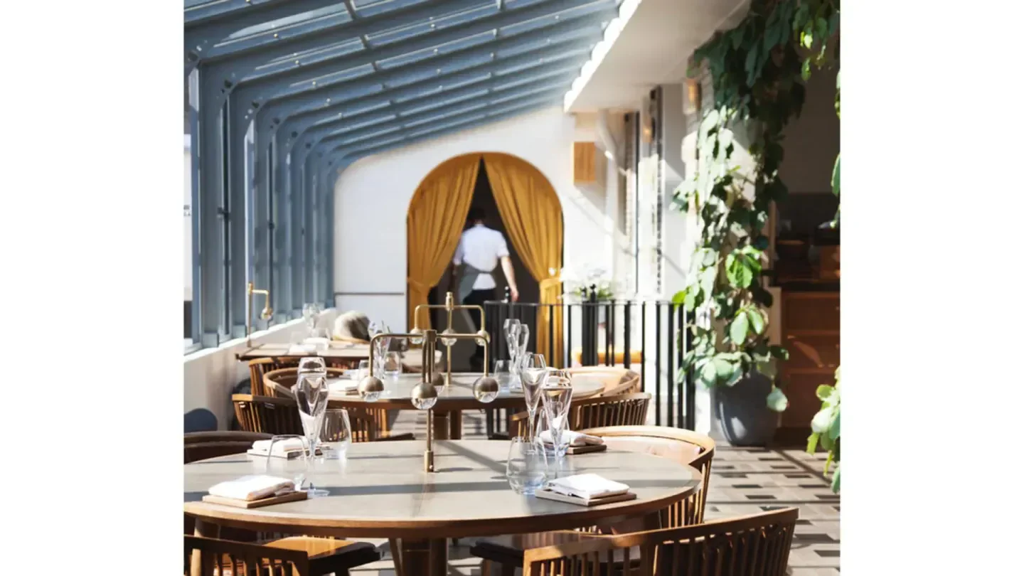 Elegant dining room at Alouette restaurant in Copenhagen, with a touch of nature.