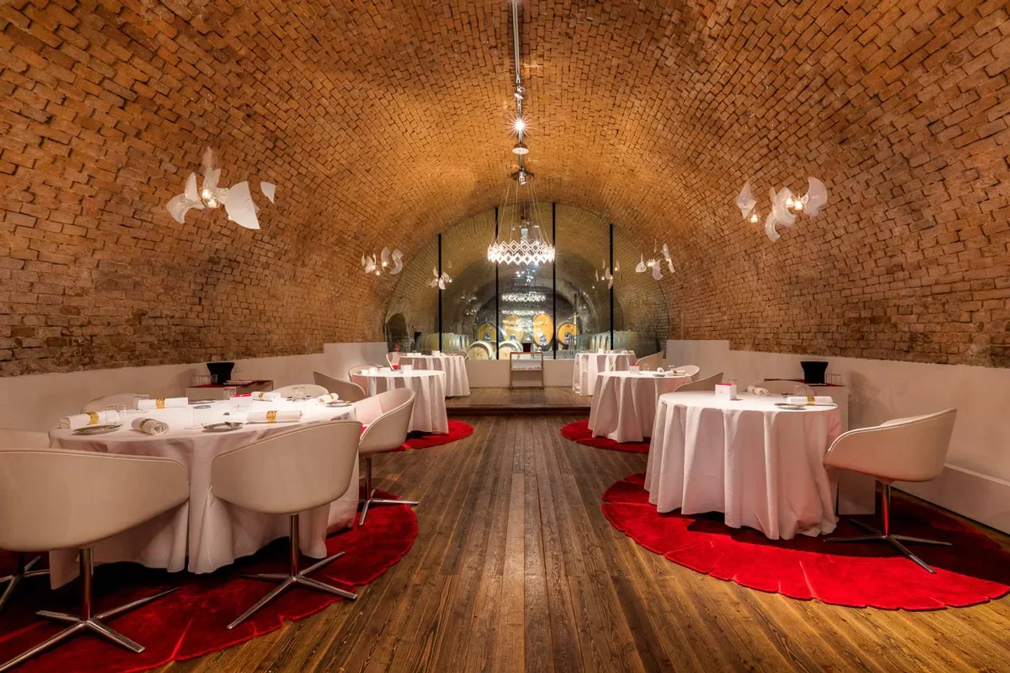 Elegant dining at Amador restaurant in Vienna, with a vaulted brick ceiling and red accents
