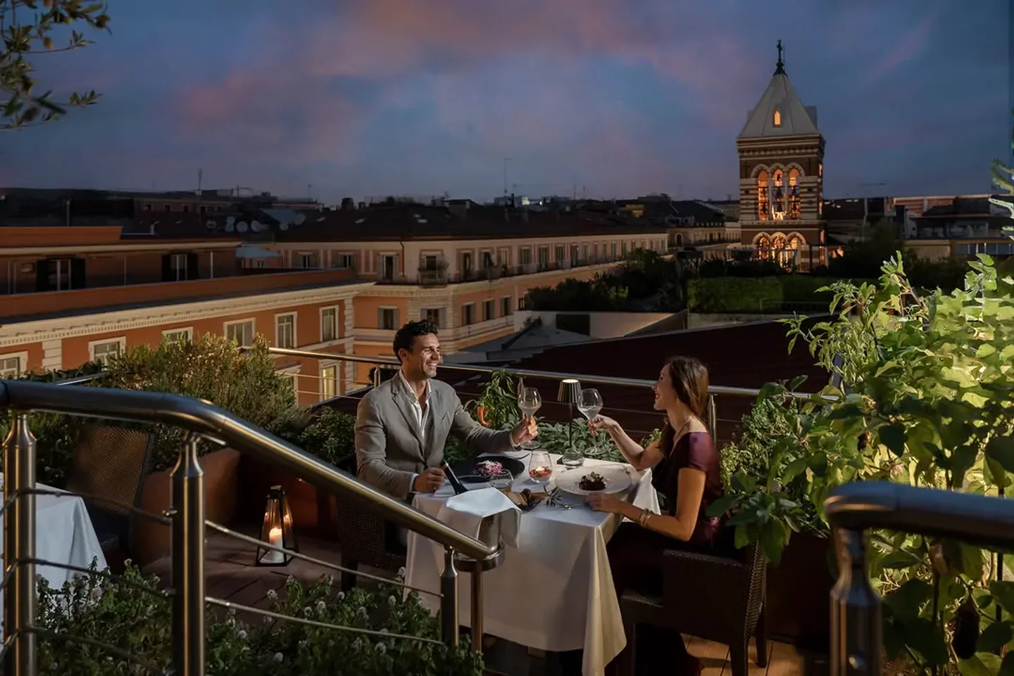 Romantic rooftop dining at Ambrosia in Rome, a perfect evening with city views.
