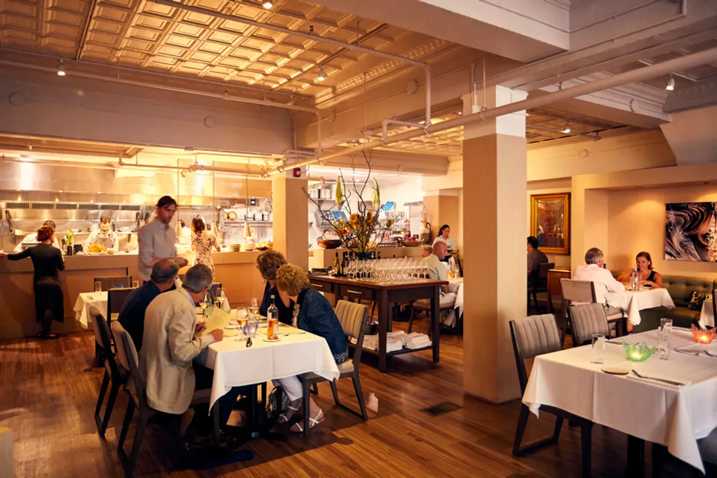 Inside Andiario in Philadelphia, a restaurant with a bustling open kitchen and dining area.