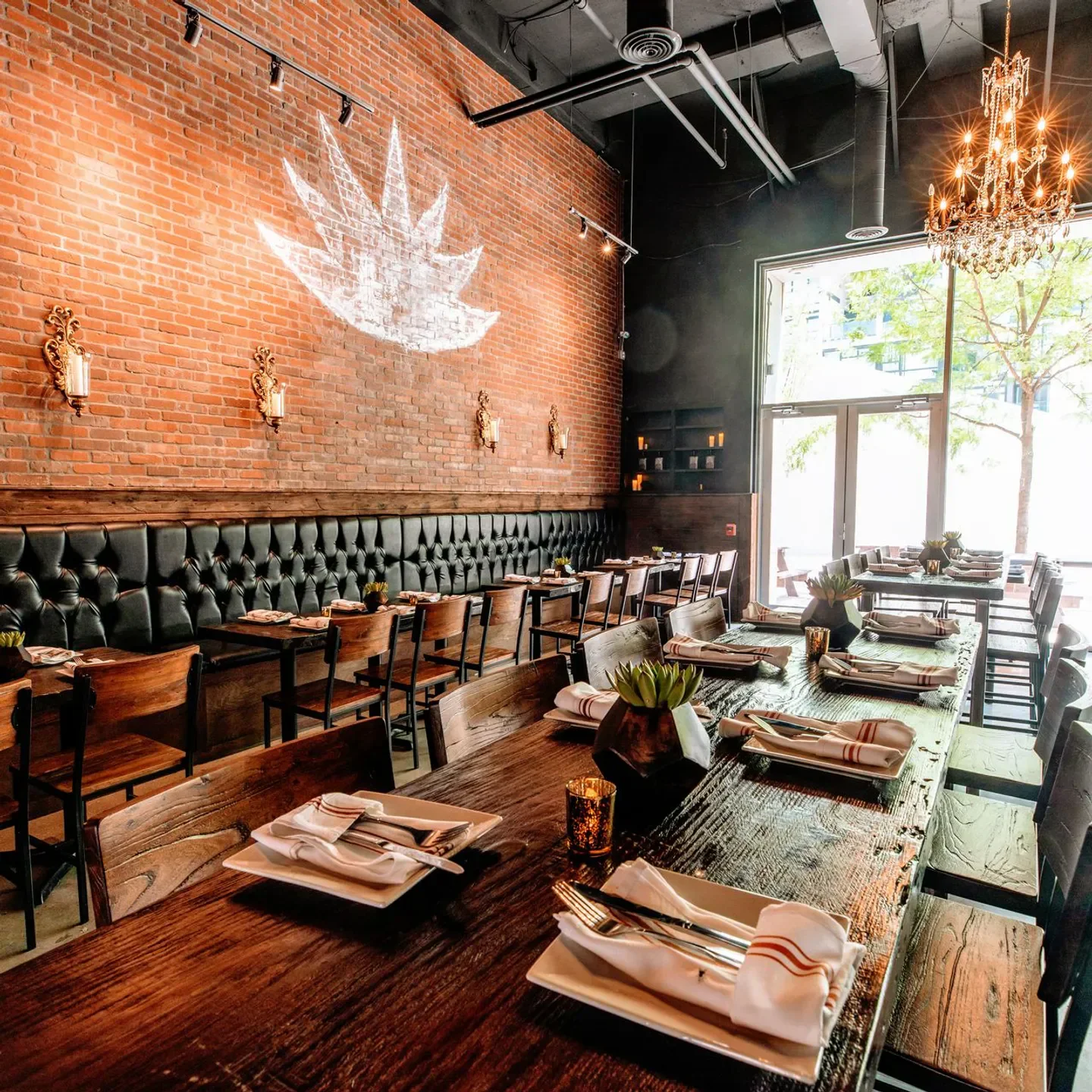 Interior of Añejo - Philadelphia, featuring long wooden tables, brick walls, in Philadelphia.