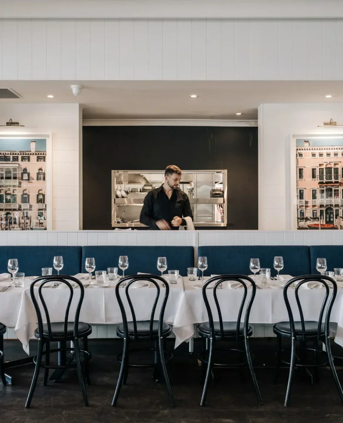 Elegant dining at Angelo's Cabarita restaurant in Sydney, featuring a chef and stylish decor.