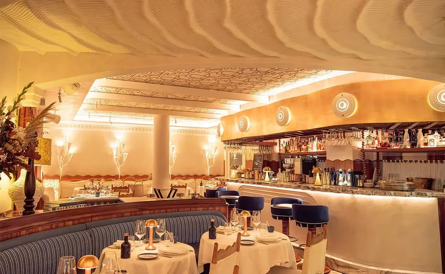 Stylish interior of Anna restaurant in Paris, featuring a unique wavy ceiling design