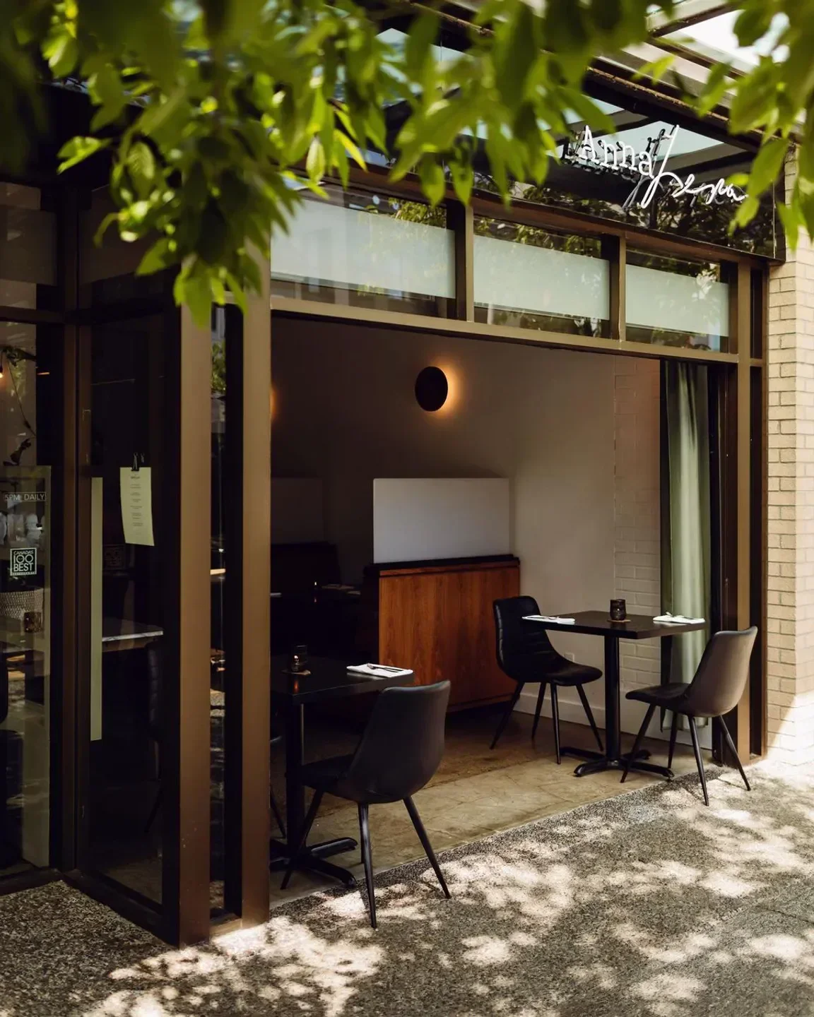 Exterior of AnnaLena restaurant in Vancouver, with tables set for dining.