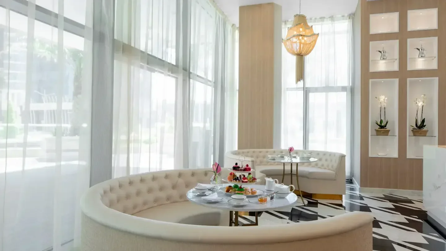 Elegant interior of Antoinette's restaurant in Doha, with a stylish afternoon tea setting.