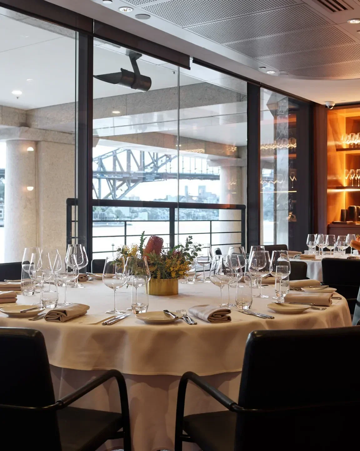 Elegant dining table set at ARIA restaurant in Sydney, with harbor views.