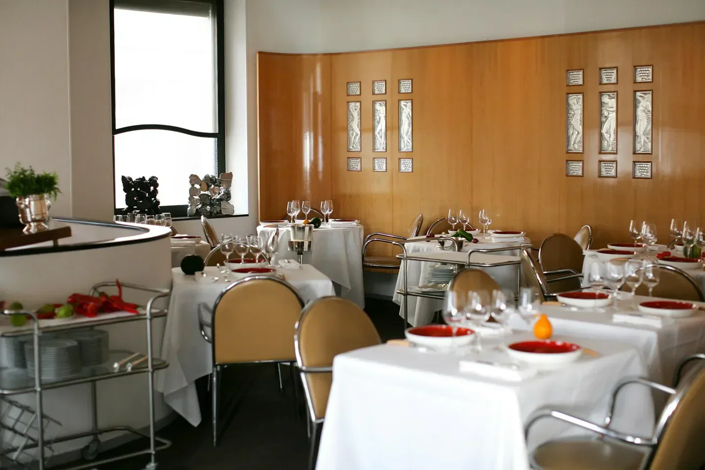 Elegant dining room at Arpège restaurant in Paris, featuring art deco design.