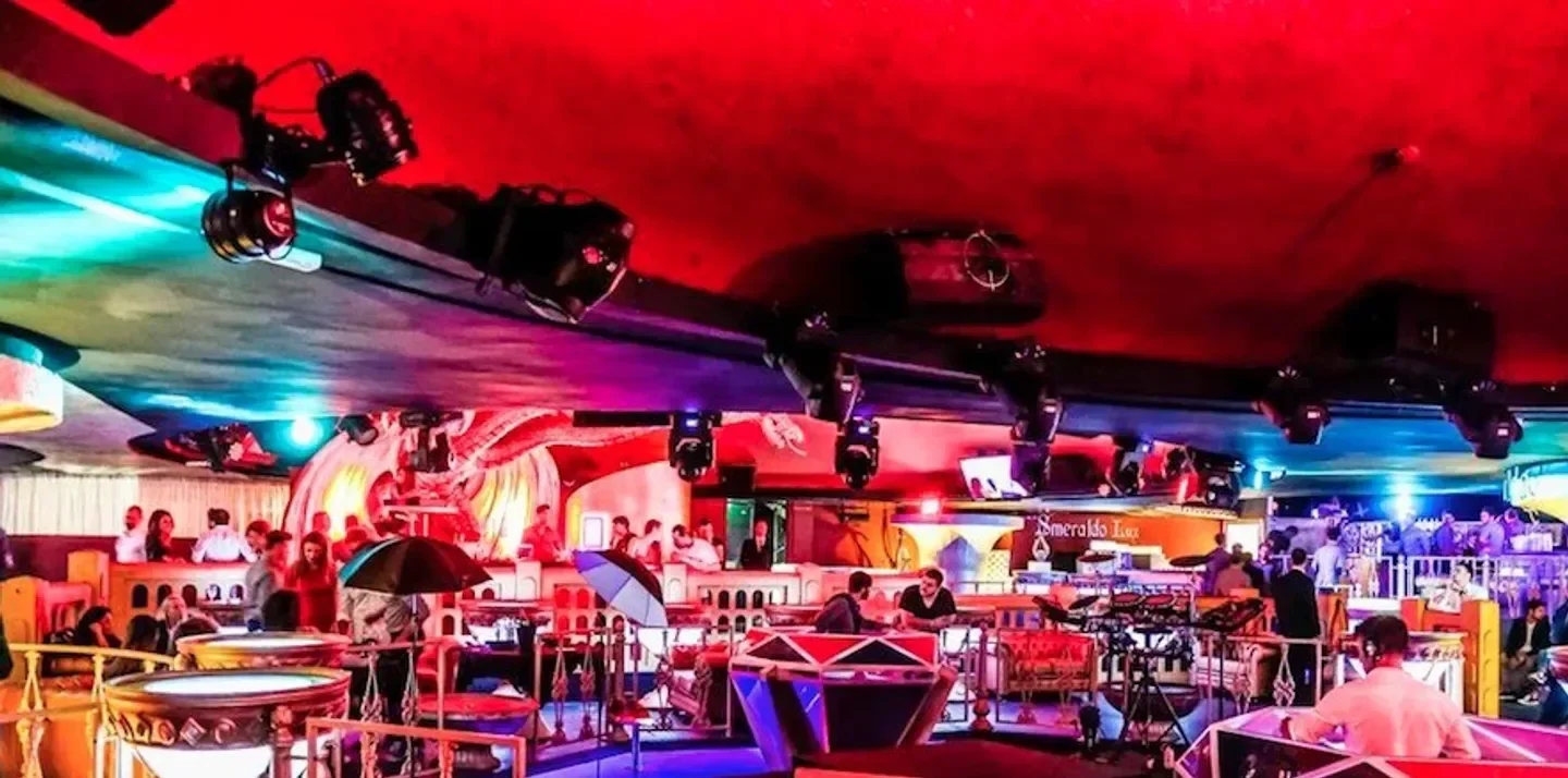 Inside Art Cafe, a vibrant nightclub in Rome, with colorful lighting and lively atmosphere.