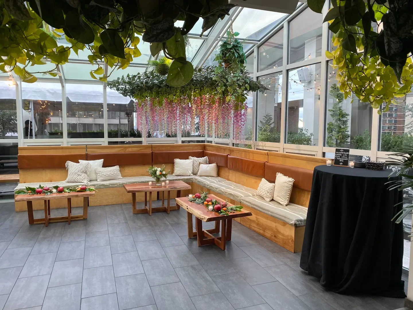 Cozy seating at Attico Rooftop in Philadelphia, featuring floral decor and city views.