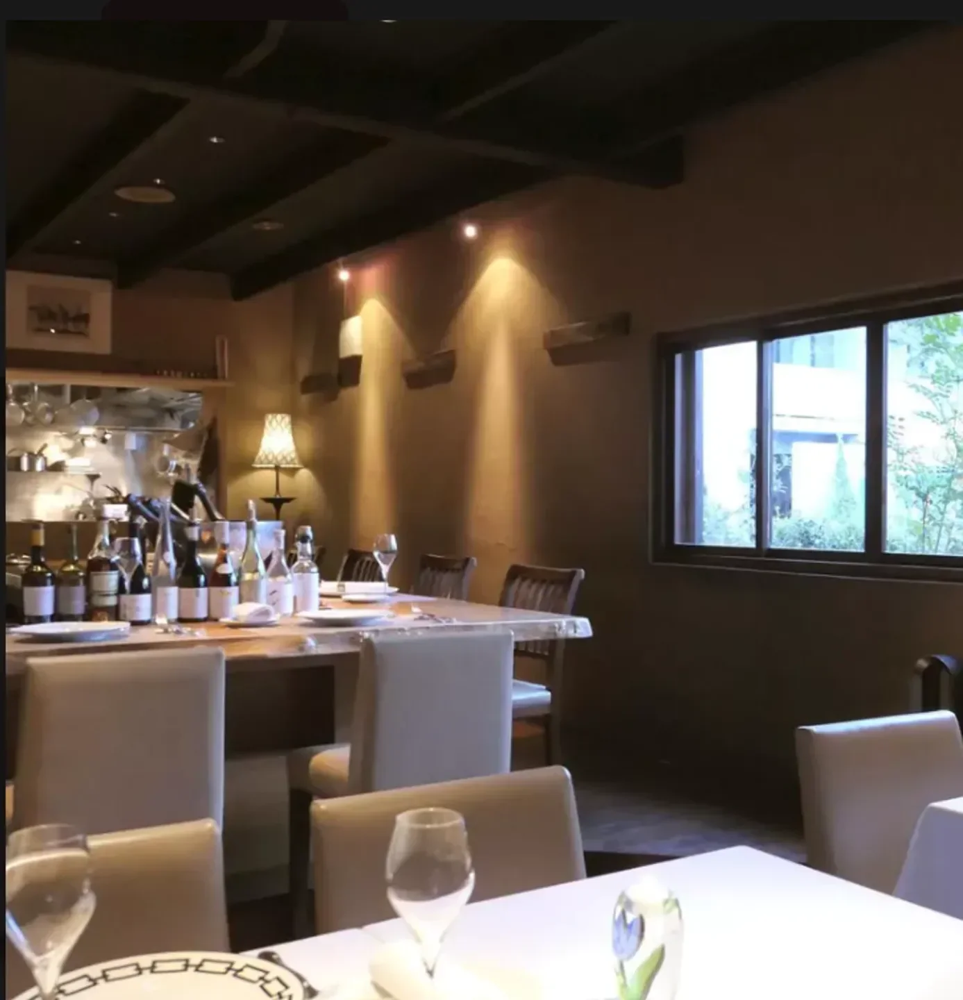 Cozy dining room at Au Deco restaurant in Tokyo, featuring tables set for dinner.
