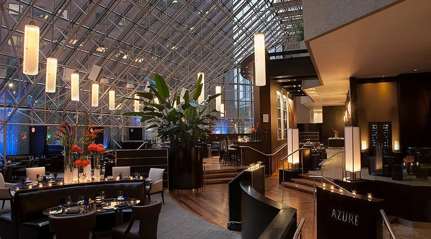 Elegant dining area at Azure Restaurant & Bar in Toronto with glass ceiling and ambiance.