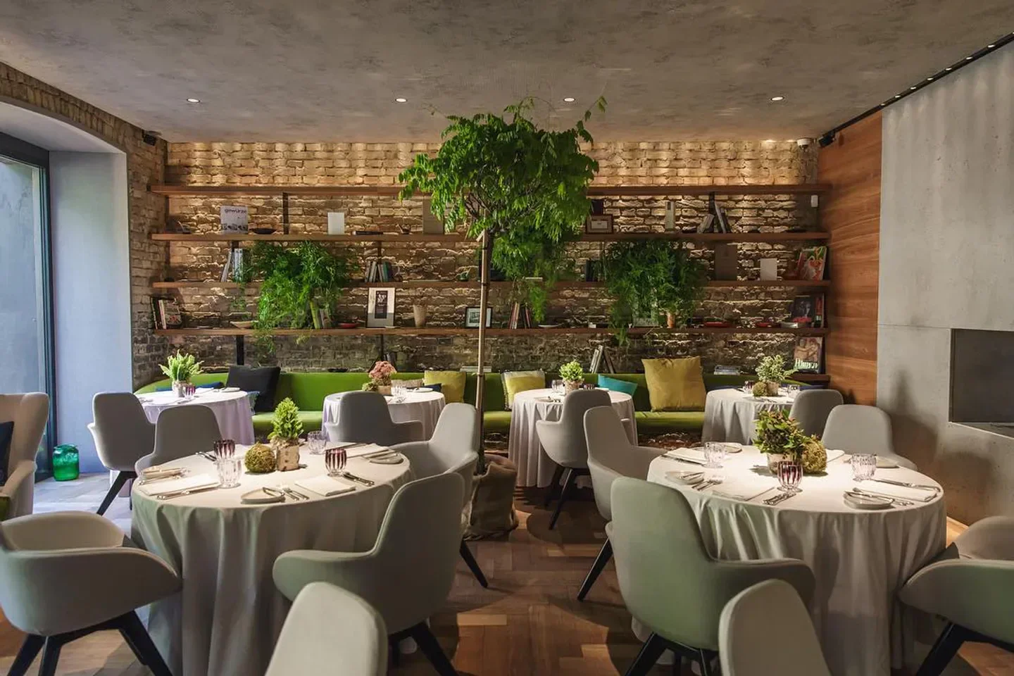 Babel restaurant in Budapest with stylish tables, plants and brick wall decor