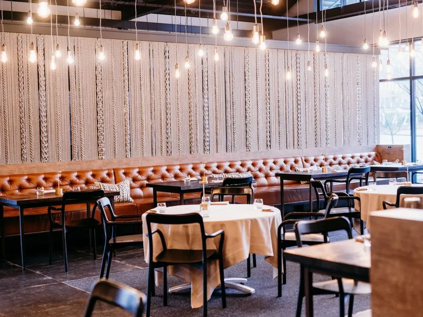 Interior of Bacchanalia restaurant in Atlanta, featuring leather booths and elegant decor.