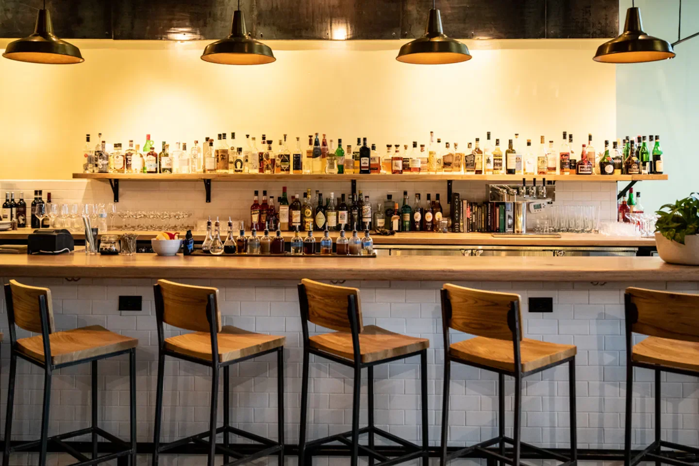 Baffi Atlanta restaurant bar with seating and a selection of spirits in Atlanta
