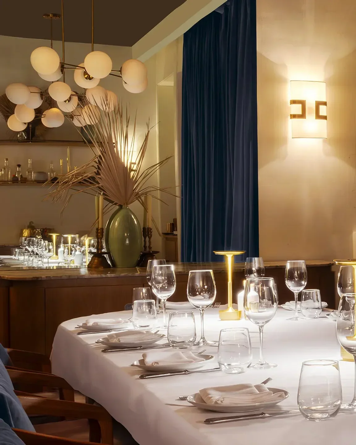Elegant dining at Bagatelle Miami. A beautifully set table with wine glasses.