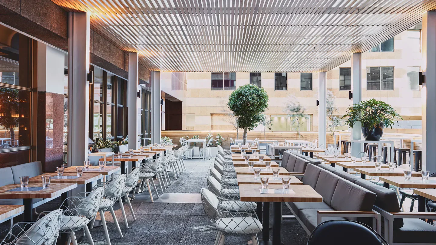 Outdoor dining area at Balcón by Tapavino in Sydney, featuring modern decor and seating.