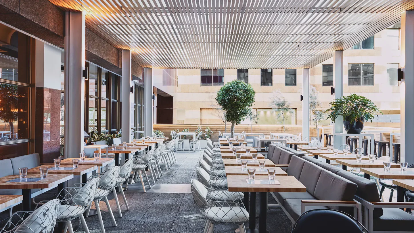 Outdoor dining area at Balcón by Tapavino in Sydney, featuring modern decor and seating.