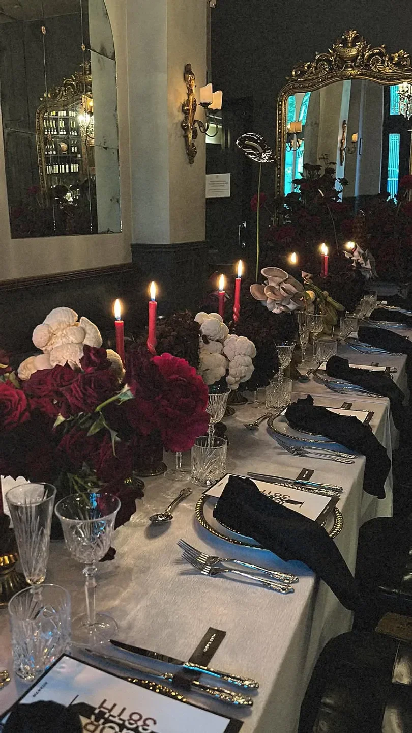 Elegant dining table setting at Bambini Trust, a restaurant in Sydney with candles and flowers