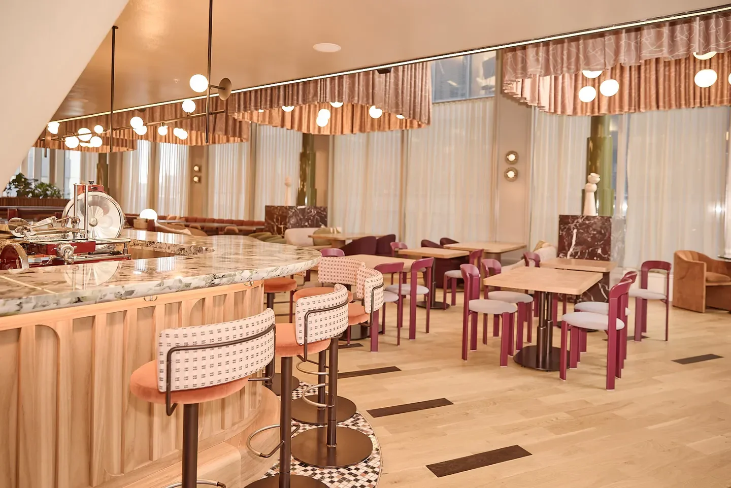 Stylish interior of Bar Lettera restaurant in Sydney, featuring bar stools and dining tables.