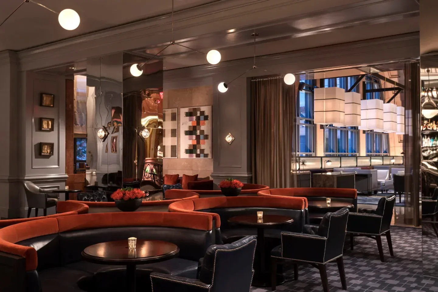 Stylish interior of Bar Margot in Atlanta, with cozy seating and unique lighting fixtures.