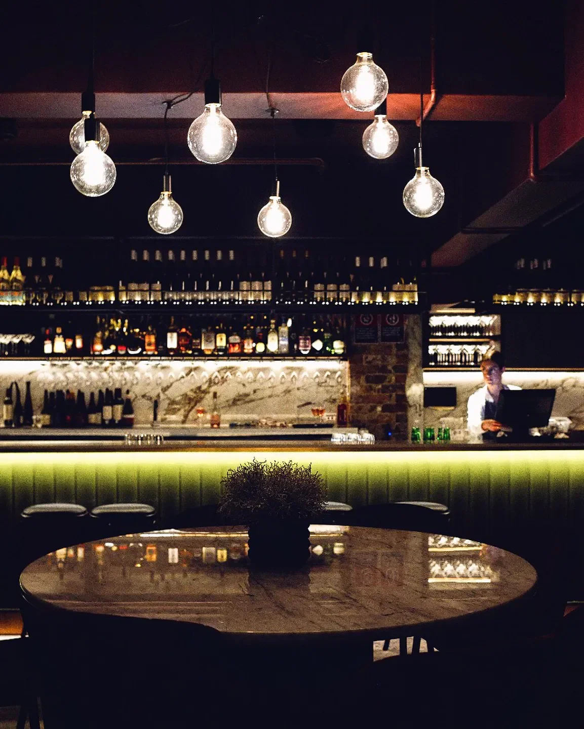 Interior of Bar Messenger in Sydney: glowing lights and a stylish bar setting.