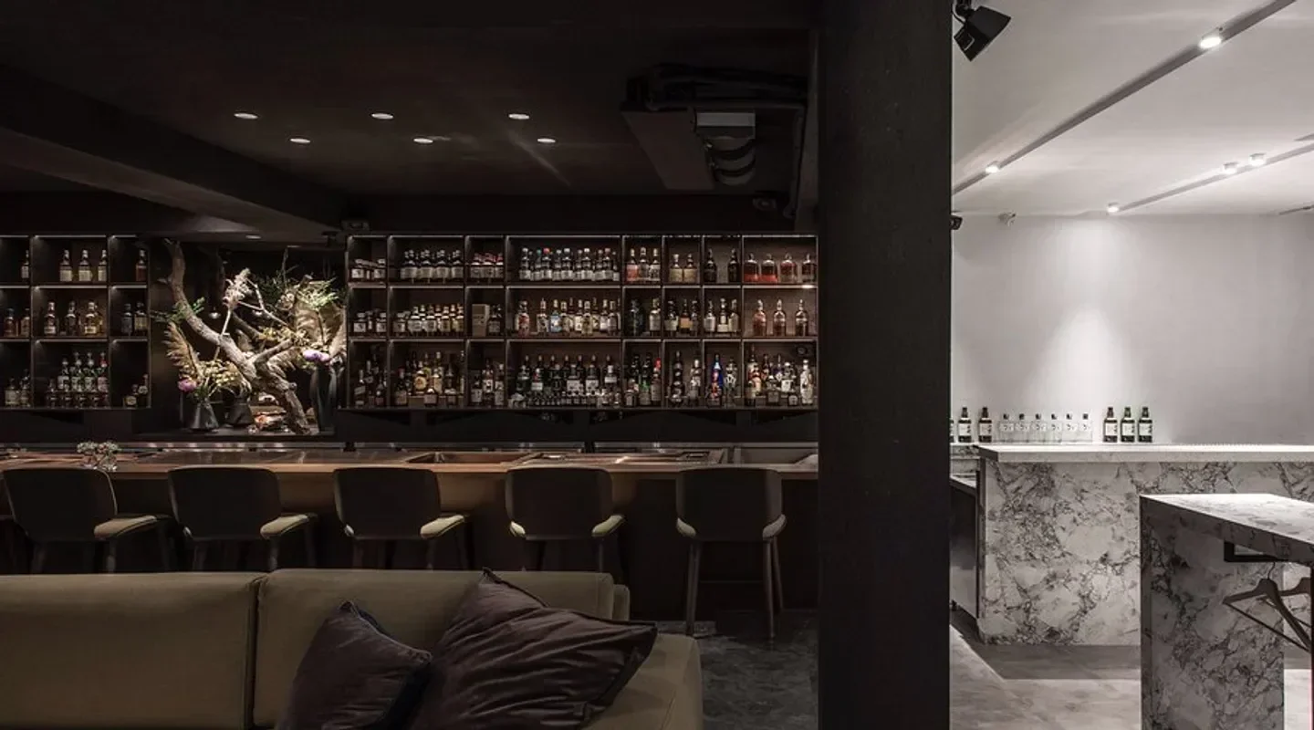 Interior view of Bar Mood in Taipei, showcasing a stylish bar area with shelves of bottles.