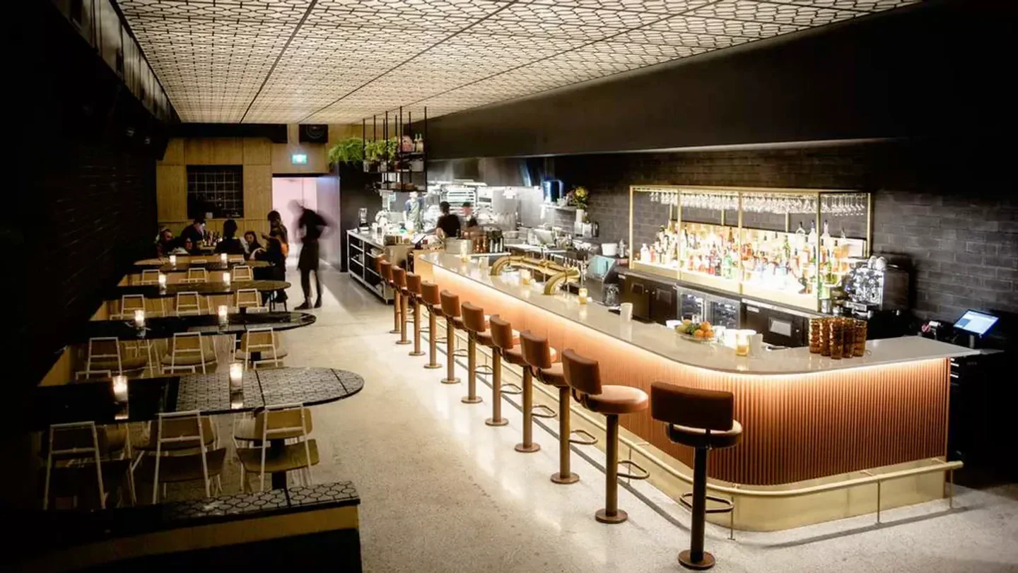 Interior view of BAR ST-DENIS restaurant in Montreal, with bar and tables.