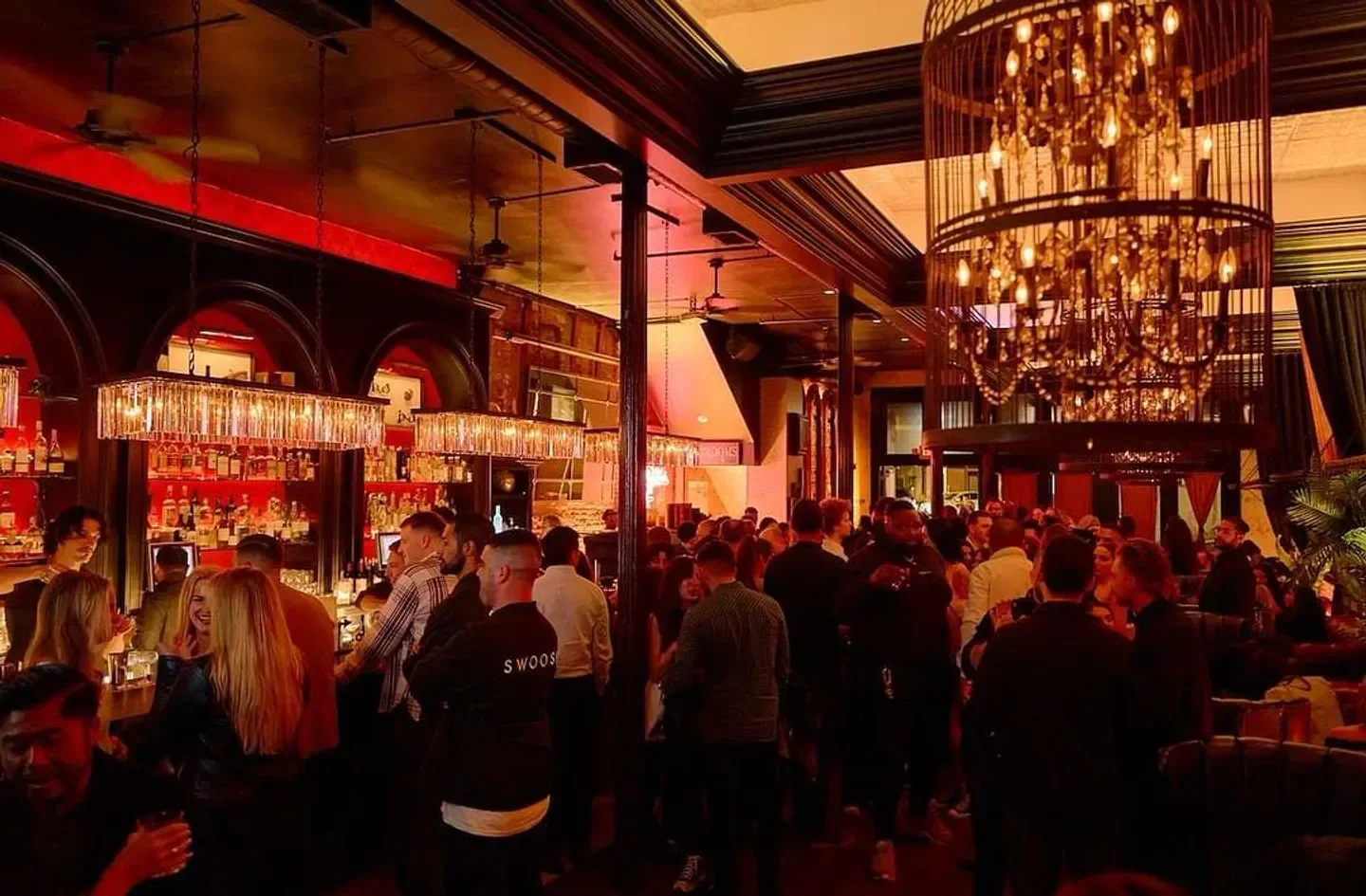 Inside Barbarossa Lounge in San Francisco, with a crowd of people at the bar