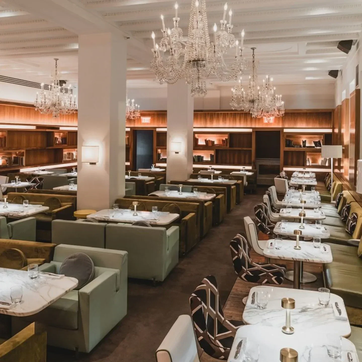 Elegant interior of Barclay Prime restaurant in Philadelphia, featuring chandeliers and booths.