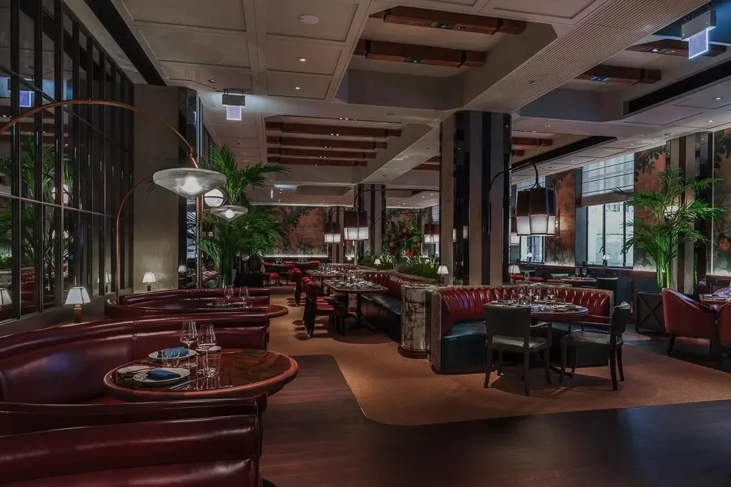 Elegant dining area at Bâtard restaurant in Hong Kong with stylish booth seating.